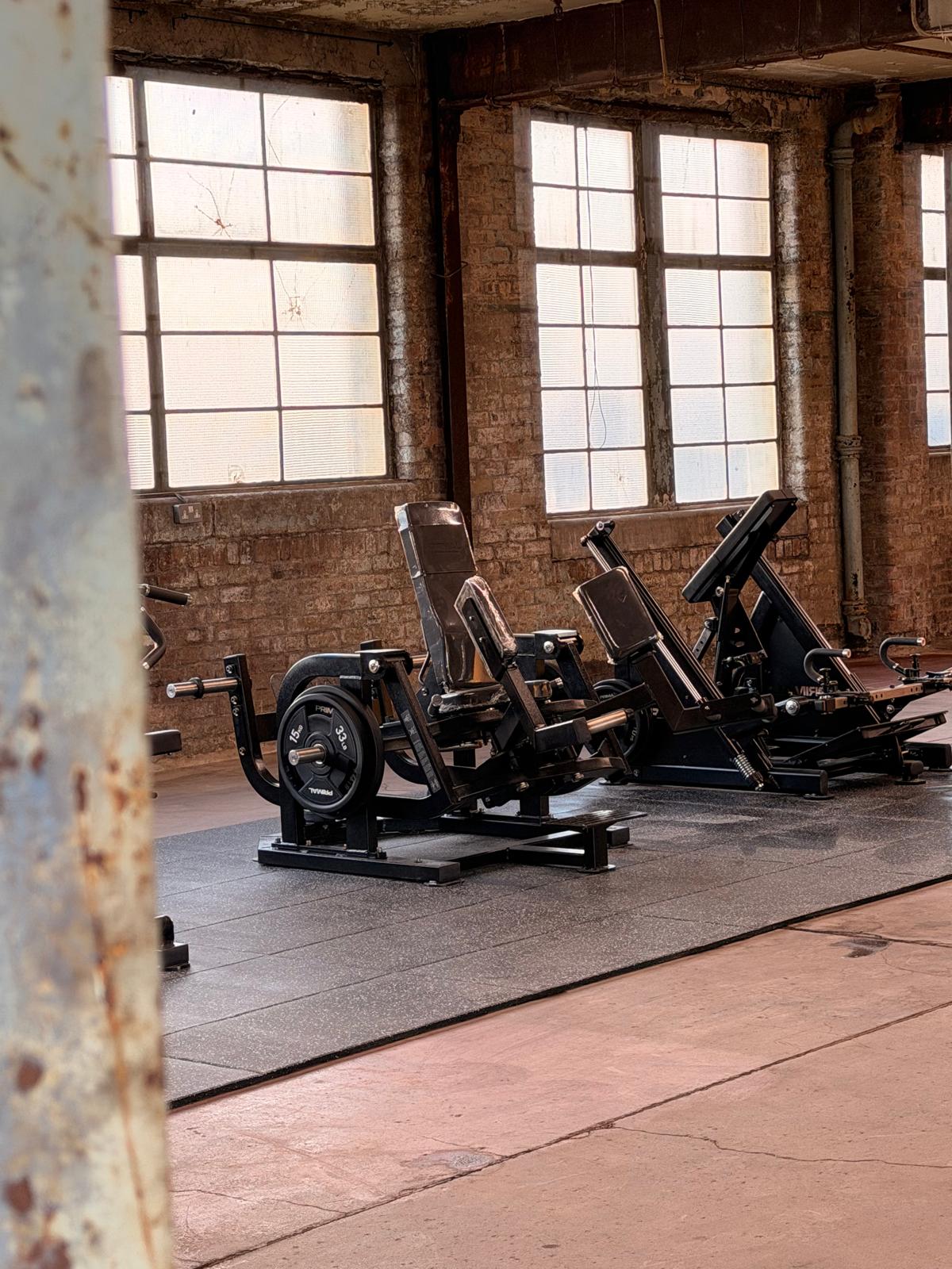 Commercial gym equipment staged in the industrial Eisen Hub production space